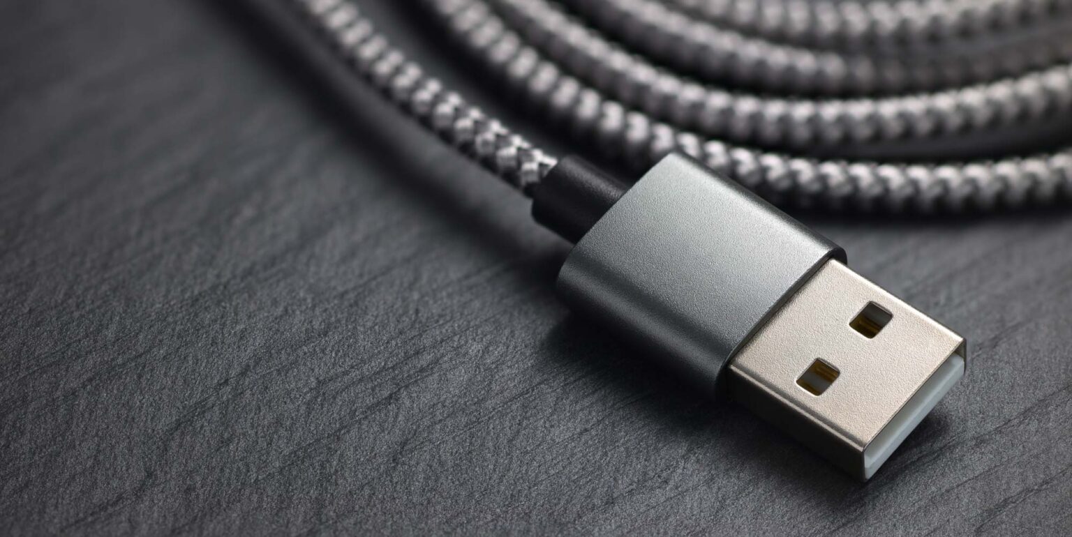 A USB cable with a silver connector and braided cable.