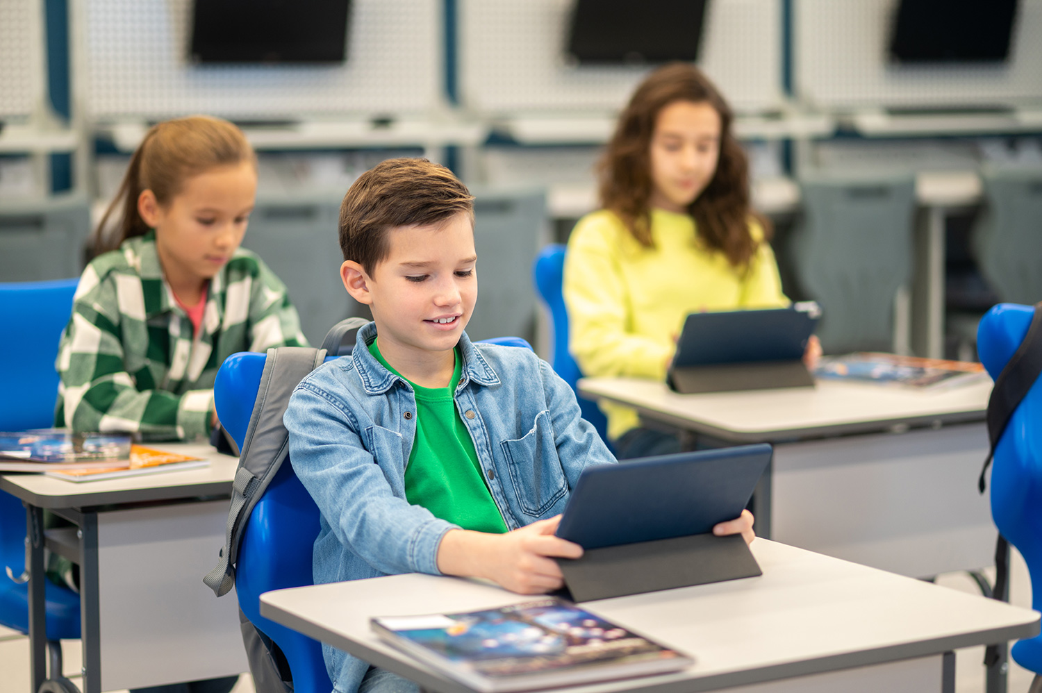 Classroom of students working on digital tablets.